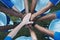 Hands stacked, above and men on a soccer field for support, motivation and team spirit. Sports, training and athlete