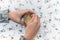 Hands stirring a cup of coffee on a flowery background