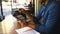 Hands, tablet and remote work in a cafe with a man entrepreneur at a table for research or planning. Technology