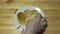 Hands take pancakes in the shape of heart with a white plate.