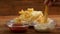 Hands taking french fries from a plate