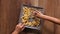 Hands taking french fries from a rectangular plate