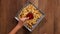 Hands taking french fries from a rotating plate