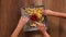 Hands taking french fries from a rotating plate