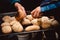 Hands taking out home made small wheat corn breads out of stove