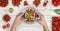 hands taking photo of food with the smartphone from above saucepan and tomatoes sauce on kitchen white wooden worktop, copy space