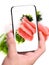 Hands taking photo pieces of tuna and salad with smartphone