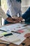 The hands of a team of businessmen joining forces celebrate the concept of unity. A close-up photo of a team working