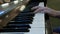 Hands teenage boy playing piano keys close up view