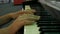 Hands teenage boy playing piano keys close up view