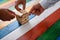 Hands of three businessmen working together to make a stack of wooden pegs