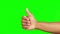 Hands, thumbs up and winning in success on green screen for good job against a studio background. Hand of person in