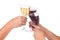 Hands toasting red and white wine in crystal glasses