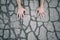 Hands touching asphalt floor