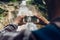 Hands Of Traveler Taking Photo Of Waterfall With His Smartphone Development Technologies For Tourism Concept