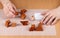 Hands trying to constructed the details of a disassembled wooden puzzle