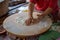 Hands of Turkish cook preparing potato and cheese gozleme on wooden table. Traditional stuffed pancakes in Alanya