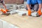 Hands of two builders laying paving stones