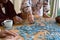 Hands of two diverse senior women and african american male friend doing puzzles