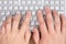 Hands typing on a computer keyboard