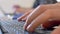 Hands typing on a modern trendy keyboard. Online concept. Work from home. Close up on man s hands inputting information