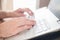 Hands typing on a notebook closeup. Workplace