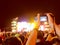 Hands of unidentified record video with digital camera during music festival concert
