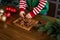 hands of unrecognisable child playing with gingerbread men cookies in wooden tray at Christmas decorated kitchen