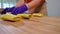 Hands of unrecognizable cook folding thin pancakes with sweet filling in slow motion. Caucasian professional woman