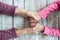 Hands of unrecognizable grandmother and her granddaughter