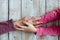 Hands of unrecognizable grandmother and her granddaughter