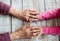 Hands of unrecognizable grandmother and her granddaughter