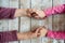 Hands of unrecognizable grandmother and her granddaughter