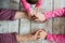 Hands of unrecognizable grandmother and her granddaughters