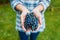 Hands of unrecognizable woman holding bunch of blue grapes