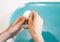 The hands of an unrecognizable woman peel a boiled egg in the kitchen. The process of cleaning eggs. A young woman is preparing Br