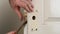 Hands use rusty chisel to make hole for door lock