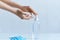Hands using alcohol gel or antibacterial sanitizer soap. Clear sanitizer in pump bottle, for killing germs, bacteria and