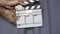Hands using movie production clapper board