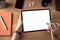 Hands using tablet with blank screen and holding digital pen, smartphone with camera and accessories on wood table.