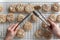 hands using tongs to transfer freshly baked cookies to a cooling rack