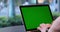 Hands using typing green screen laptop computer