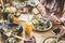 Hands view of young people eating brunch and drinking smoothies bowl with ecological straws in plastic free restaurant - Healthy