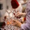 Hands of waiter in rubber gloves making a pyramid out of glasses for drinks, wine, champagne, festive mood, celebration