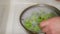 Hands Washing Celery in a Bowl