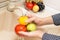 Hands washing tomato, apple and lemon in the sink on kitchen. Washing fruits and vegetables concept