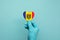 Hands wearing protective surgical gloves holding Moldova flag heart