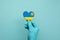 Hands wearing protective surgical gloves holding Rwanda flag heart