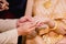 hands of a wedding couple, Groom put a ring on finger of his lovely wife, wedding ceremony