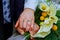 Hands with wedding gold rings happy newlyweds and bouquet flowers kala